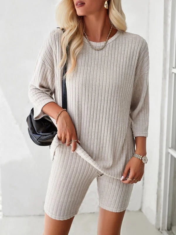 Light beige ribbed knit short suit with a relaxed fit, shown on a model.