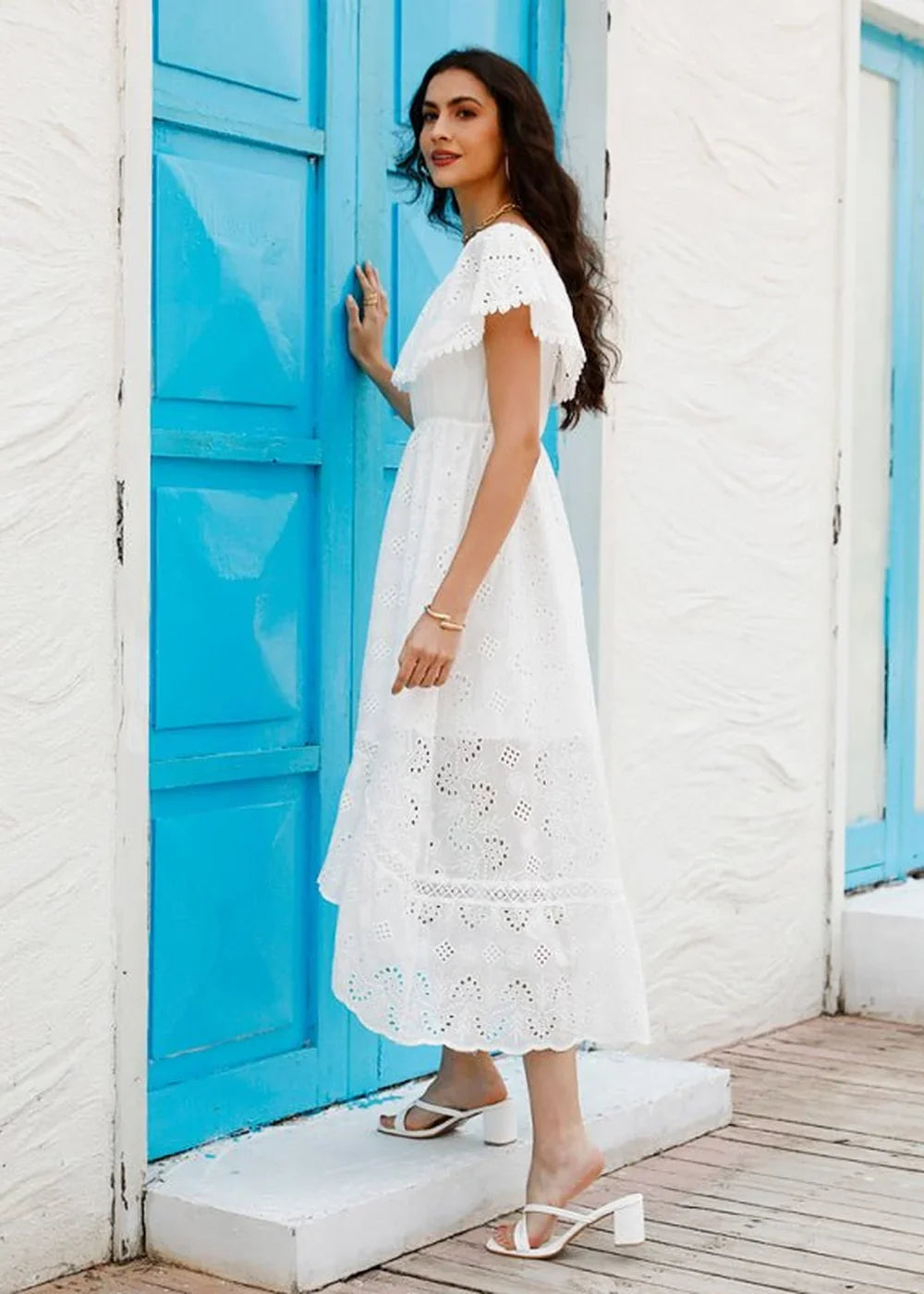 White cotton eyelet midi dress with flutter sleeves and a ruffled neckline.
