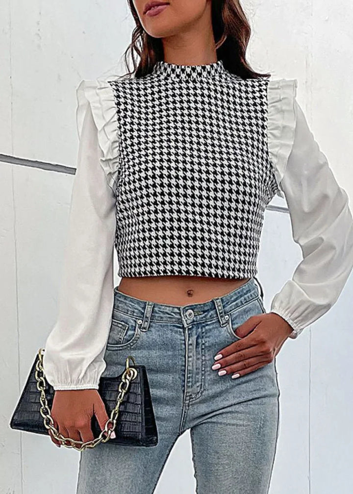 Black and white houndstooth crop top with ruffled white sleeves, paired with light wash jeans.