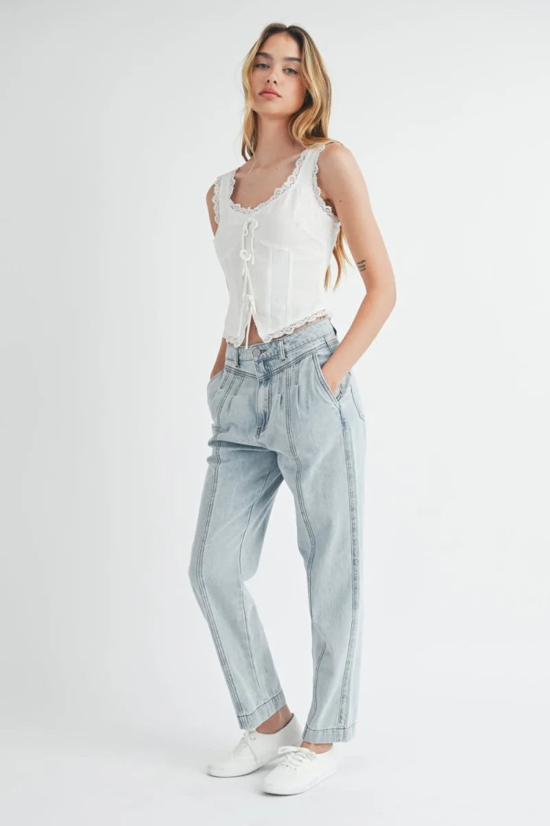 Light wash denim pants with a relaxed fit, featuring a high waist and pleated front detail.