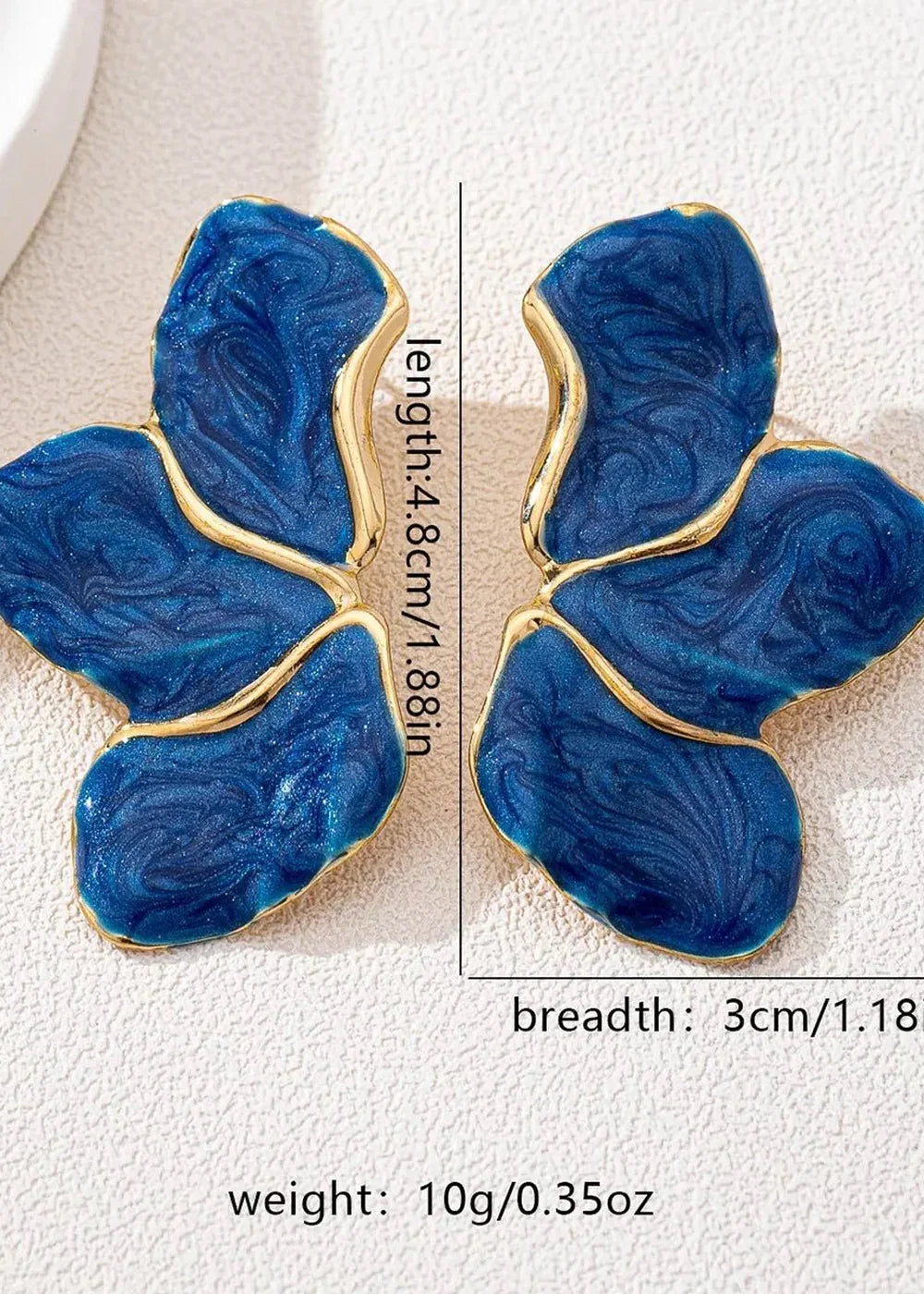 Gold-trimmed blue resin butterfly earrings with swirling patterns, length 4.8cm, width 3cm.