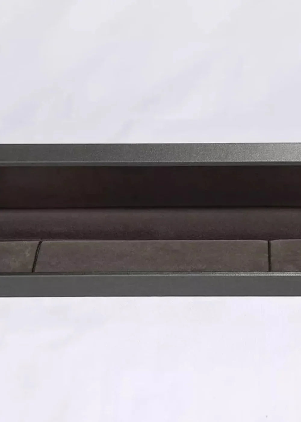 Close-up of a plush, dark brown textured fabric lining a dark gray metal frame.