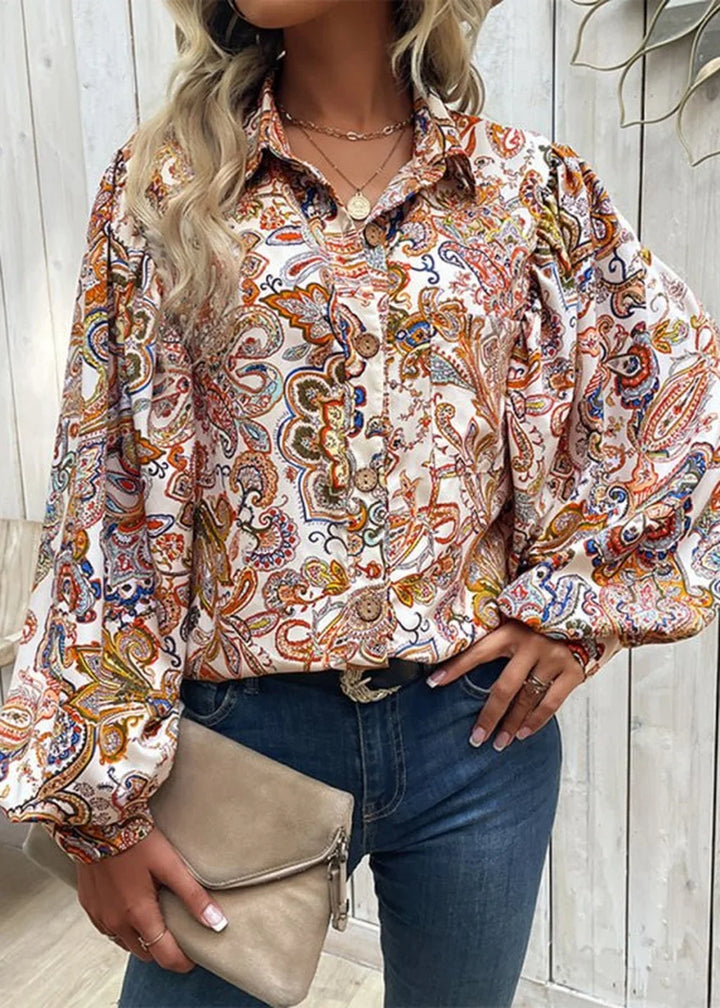 Loose fit white polyester blouse with a vibrant paisley print and balloon sleeves.