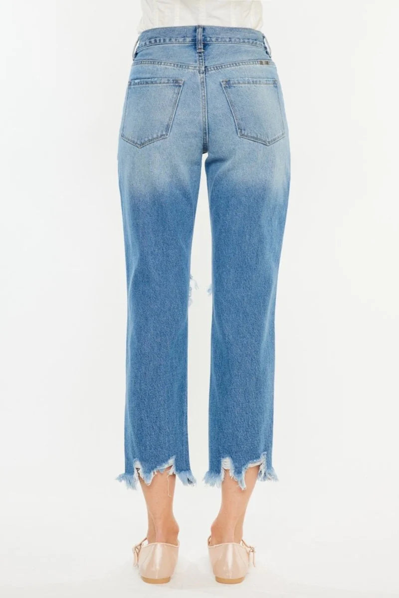 Frayed hem light wash denim jeans with a distressed look and ombre blue fade
