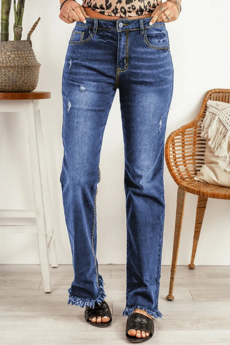 Distressed dark wash denim jeans with frayed hems and a regular fit.