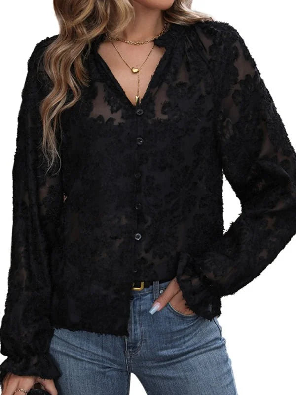 Black burnout floral sheer long sleeve blouse with button front and ruffled cuffs.
