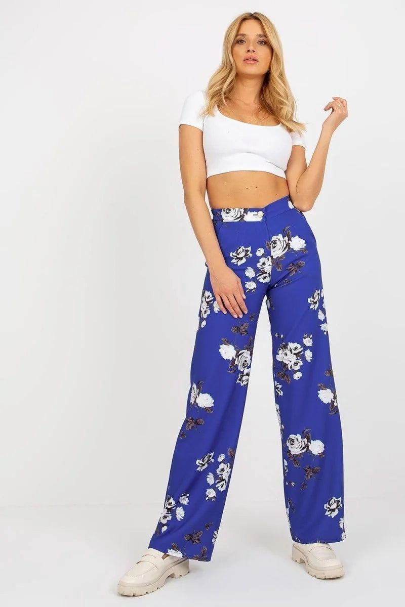 Royal blue wide-leg pants with a white and black floral pattern, worn by a model.