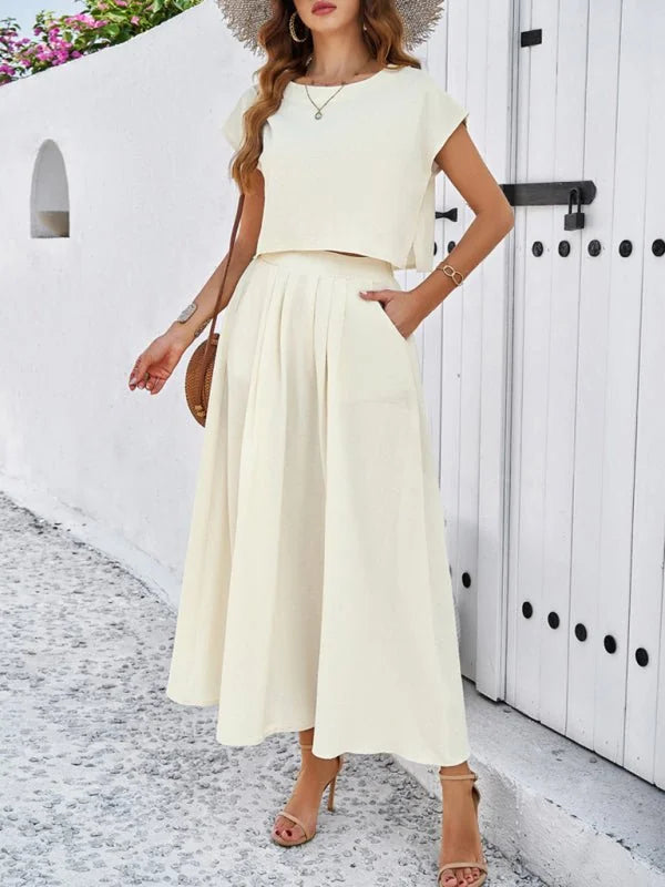 Cream linen-look crop top and pleated midi skirt set with side pockets on model.