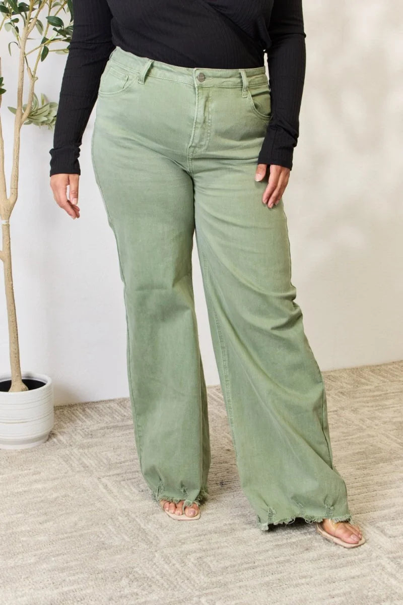 High-waisted light green wide-leg jeans with a frayed hem on a model.