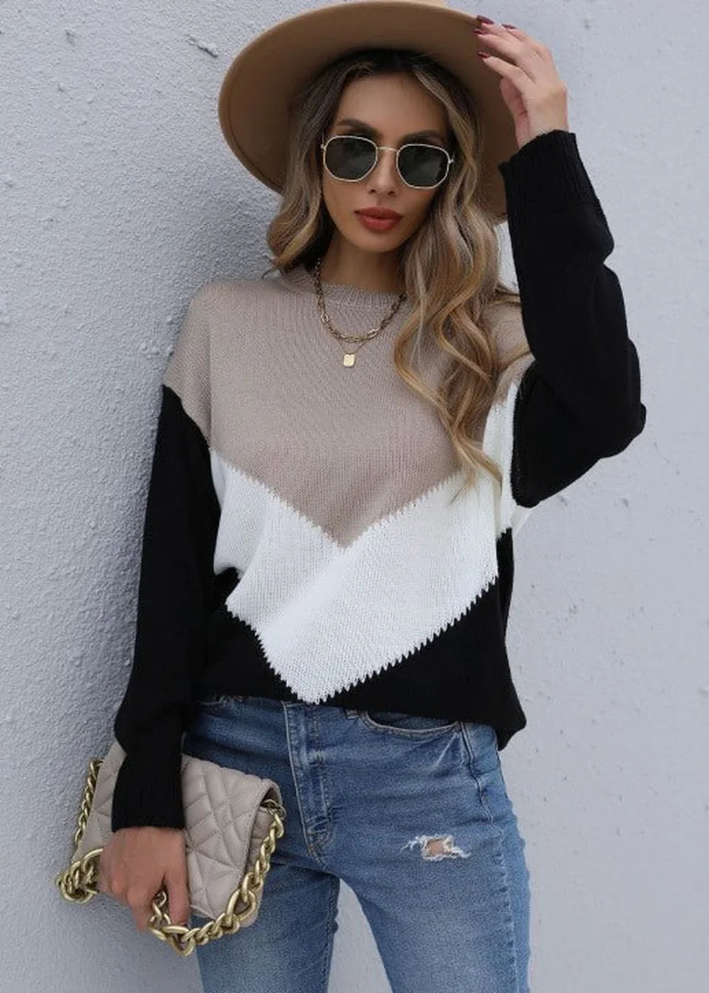 Relaxed fit colorblock sweater with black sleeves and a beige and white chevron pattern, worn by a model.