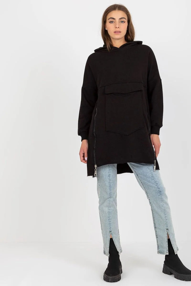 Black oversized hoodie with front pocket and side zippers, paired with light wash jeans.