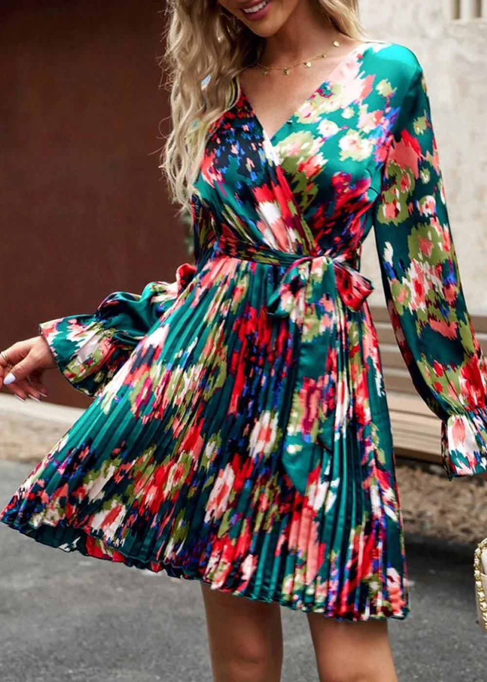 Green floral print wrap dress with pleated skirt and tie waist.