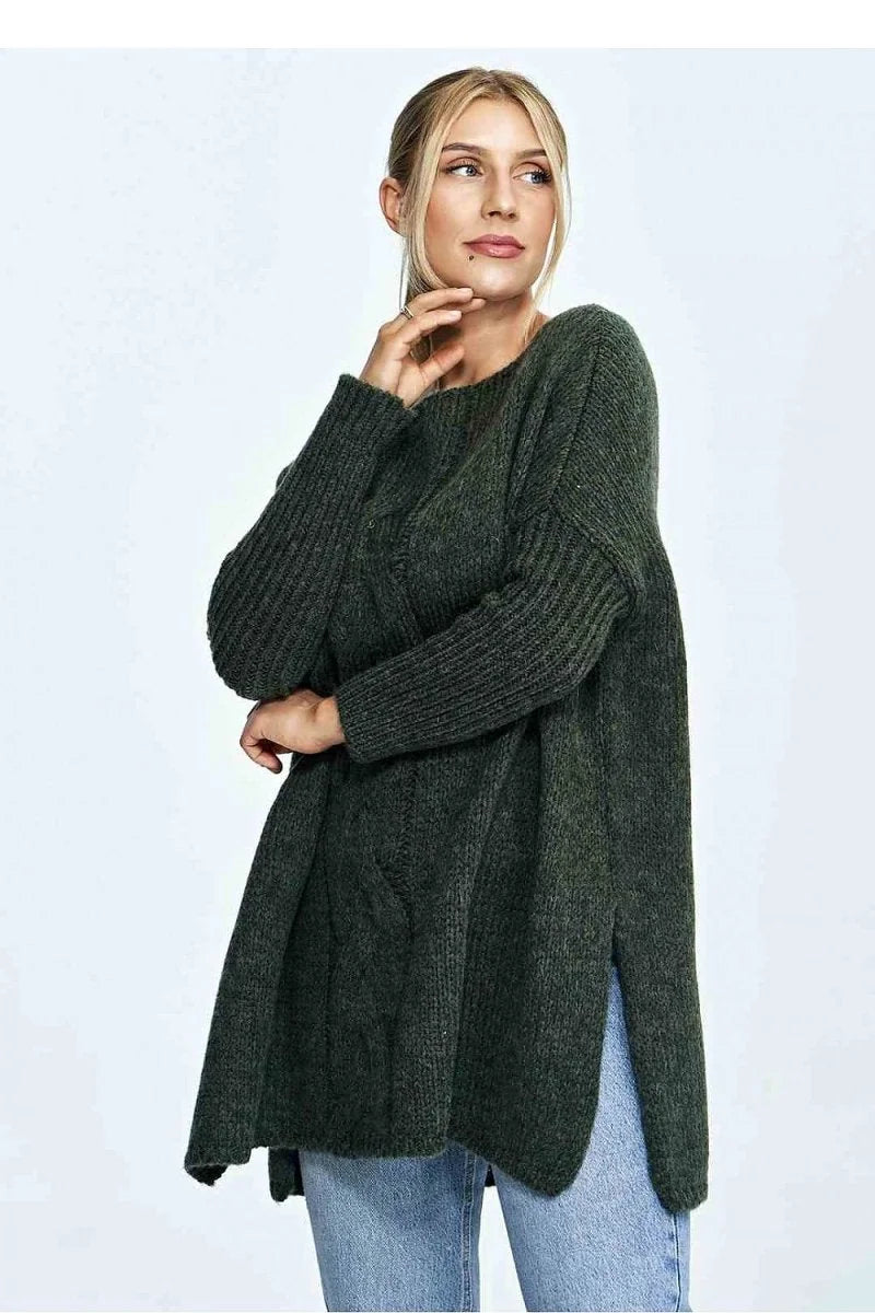 Dark green loose-fit sweater with cable knit detail and side slits on model.