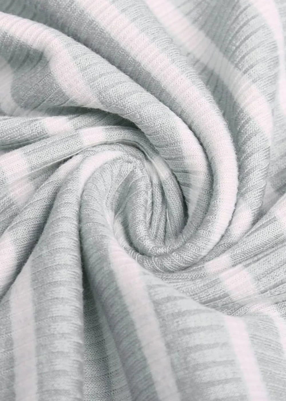 Close-up of misty grey ribbed fabric with white stripes, showing texture and soft drape.