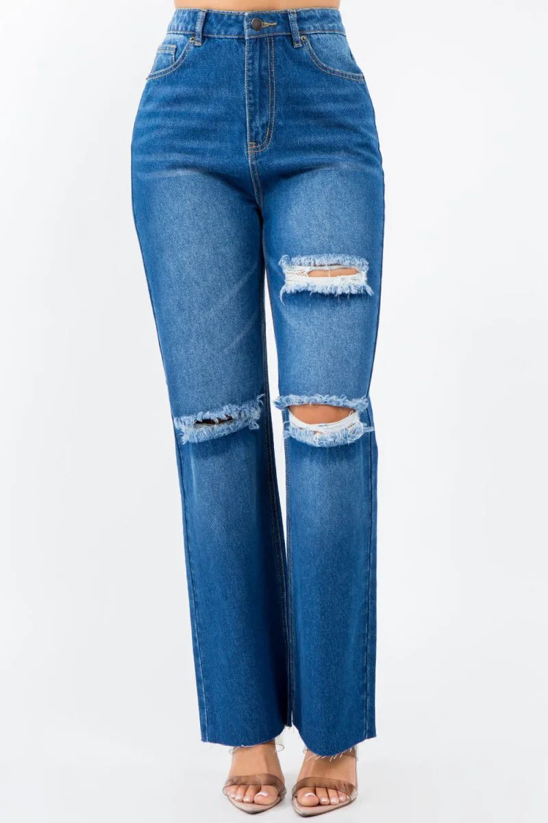 Blue distressed denim jeans with a frayed hem and ripped knees.