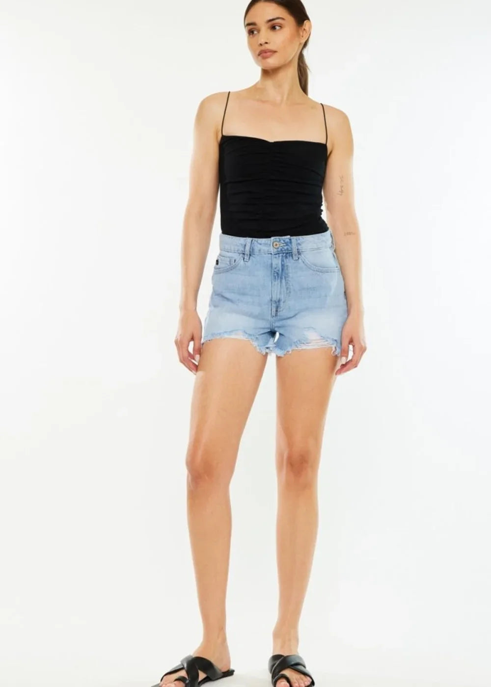 Light blue distressed denim shorts with a frayed hem and a regular fit.