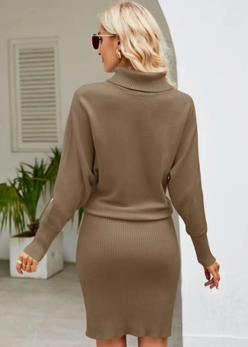 Caramel ribbed knit turtleneck sweater dress with batwing sleeves, on model.