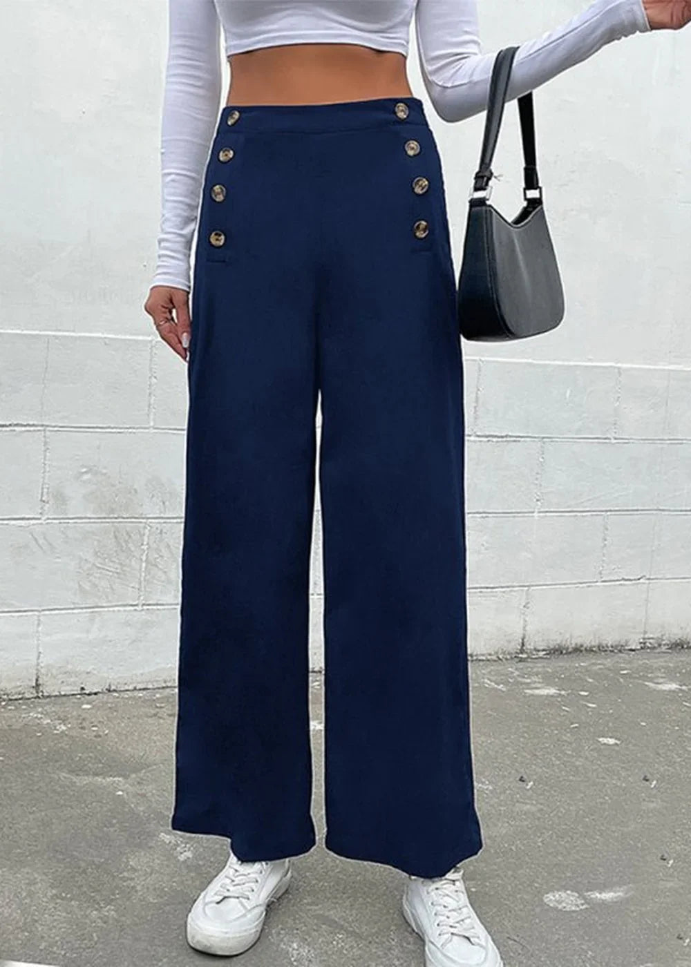 Navy blue wide-leg pants with decorative gold buttons and a high-waisted fit, shown on model.
