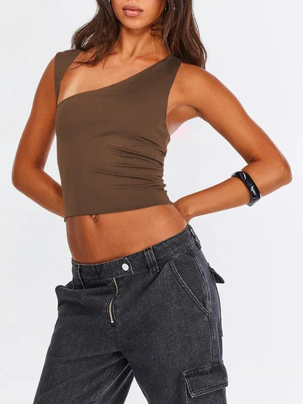 Brown one-shoulder crop top with a fitted silhouette, paired with dark wash cargo pants.