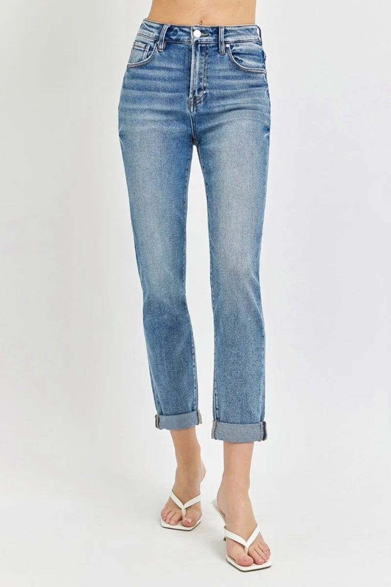 High-rise, slightly stretchy light wash denim jeans with cuffed hems, shown on model.