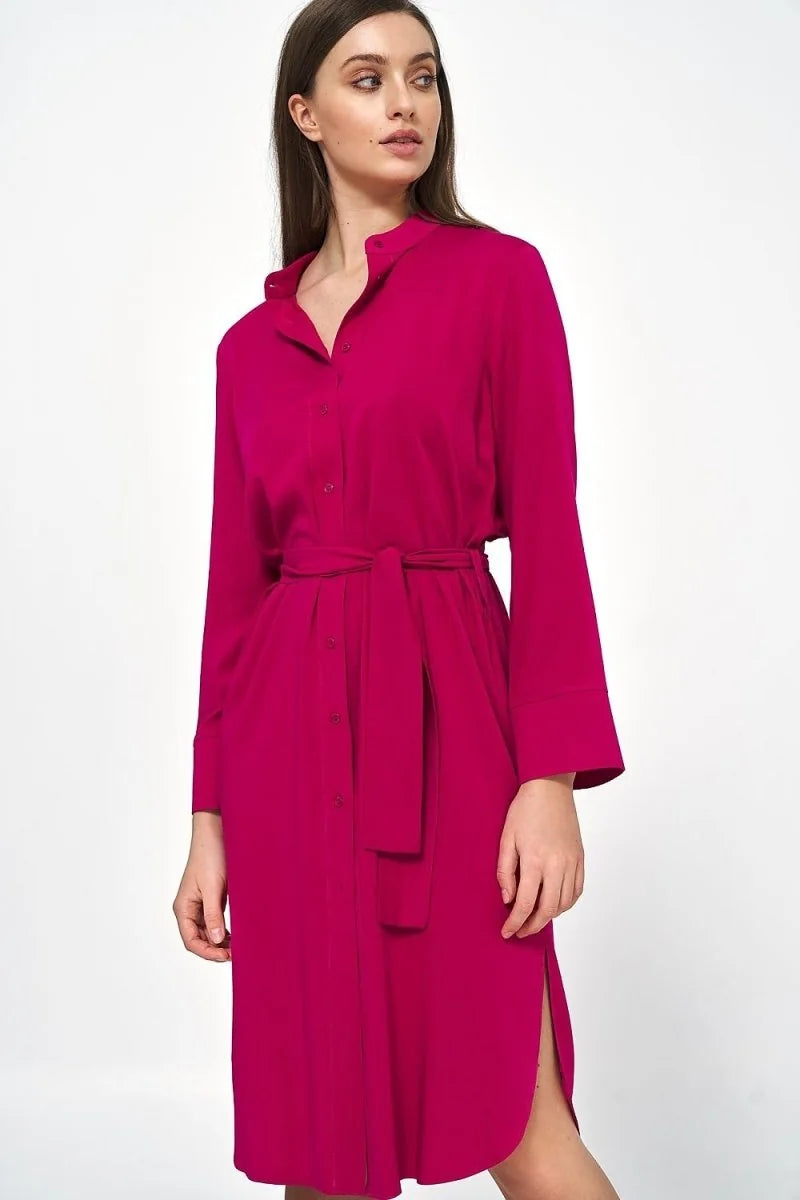 Pink viscose shirt dress with tie belt and side slits, on a model.