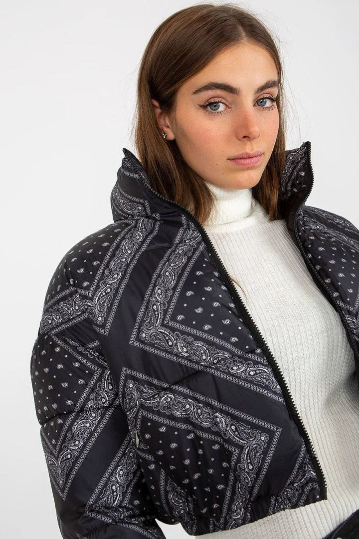 Black puffer jacket with a white paisley bandana print and a high neck.