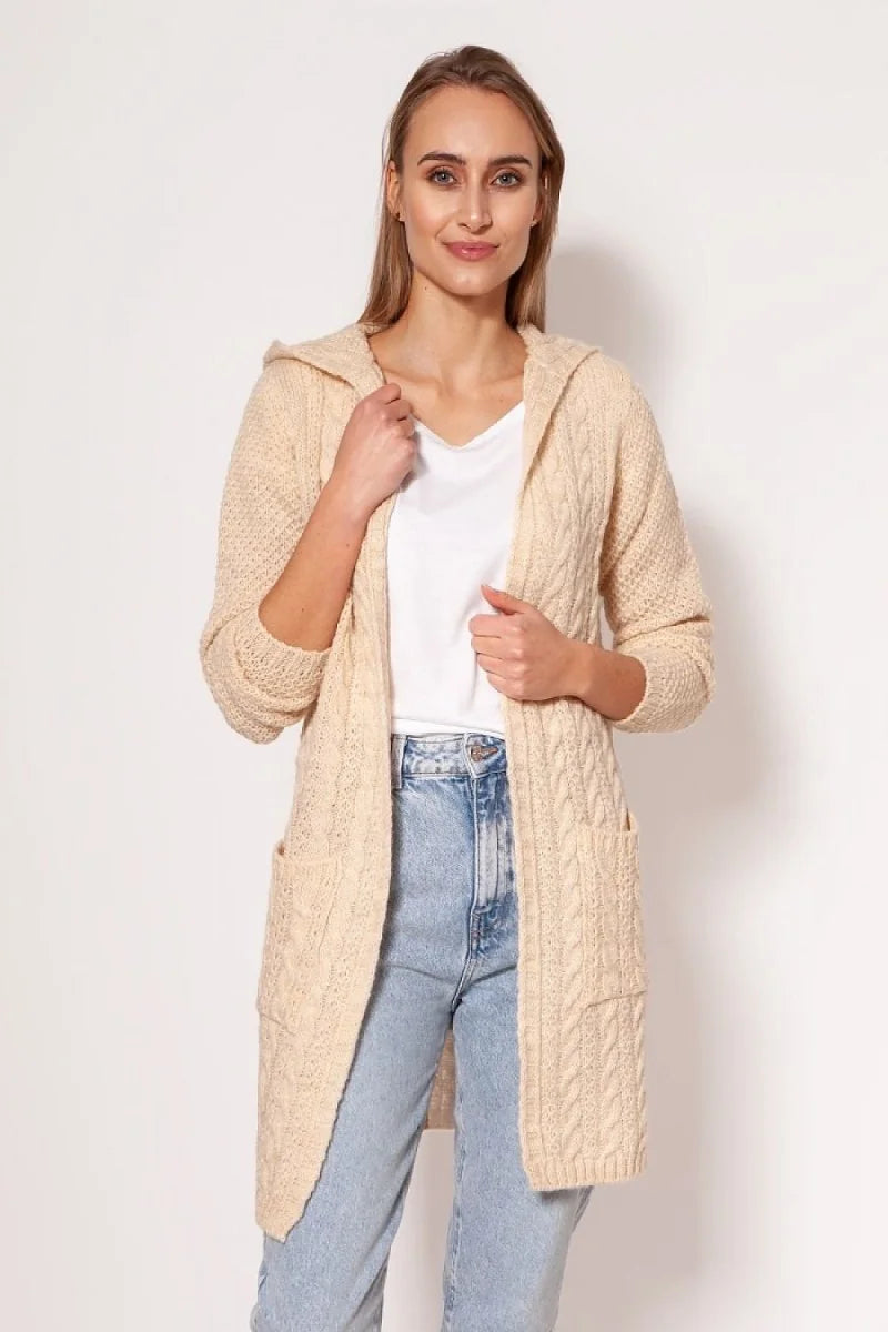 Cream cable knit hooded cardigan with pockets on a model.