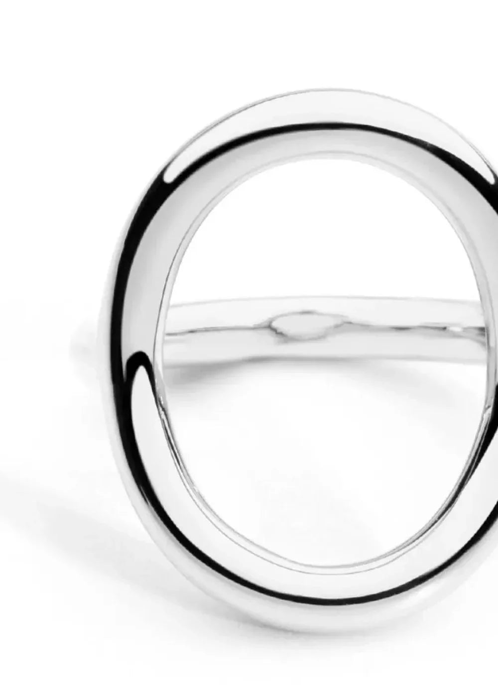Close-up of a polished silver-tone ring with a circular open design.