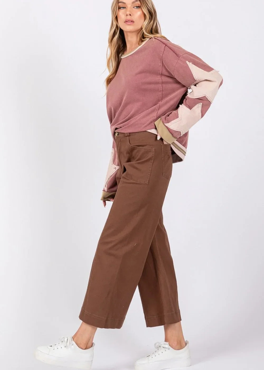 Mocha wide-leg pants with a regular fit, featuring front pockets and a visible seam detail on the hem.