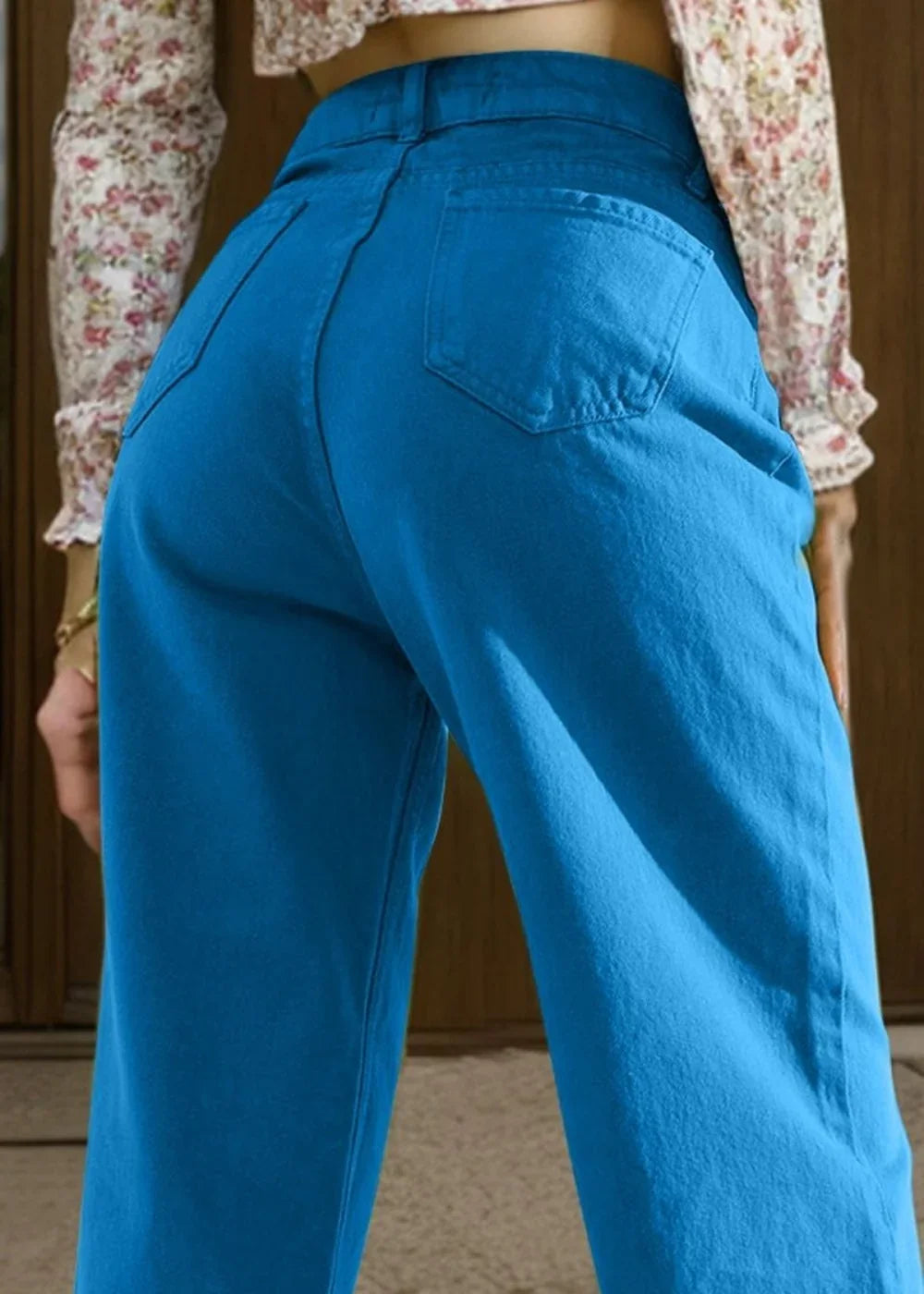 Close-up of bright blue cotton blend jeans showing back pockets and regular fit.