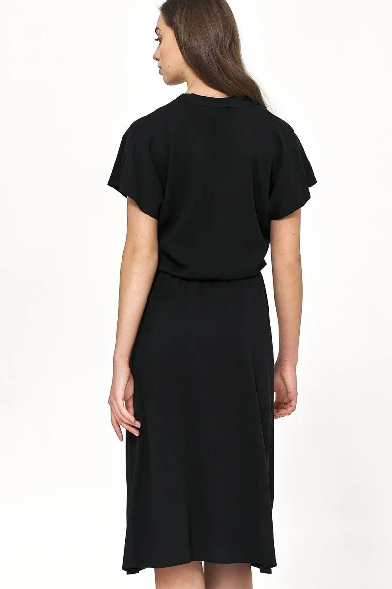 Back view of a black viscose midi dress with short sleeves on a model.