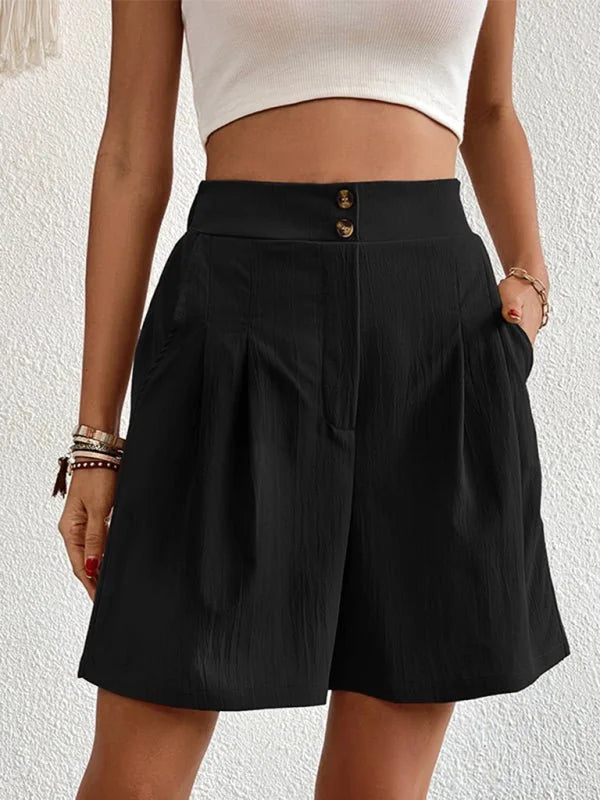 Black textured high-waisted shorts with two button closure and a regular fit on a model.