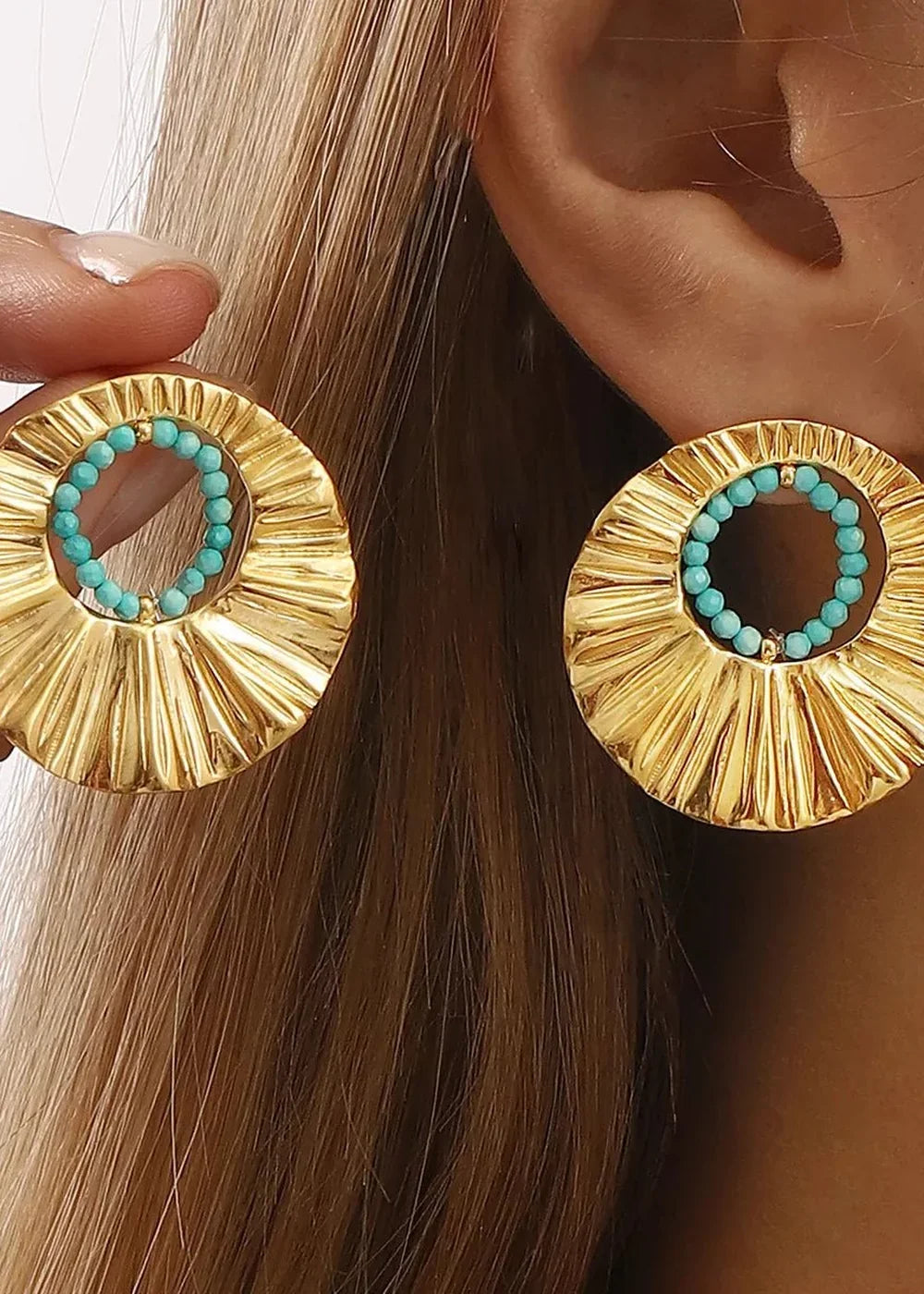 Gold-plated earrings with turquoise beads, featuring a fluted, circular design.