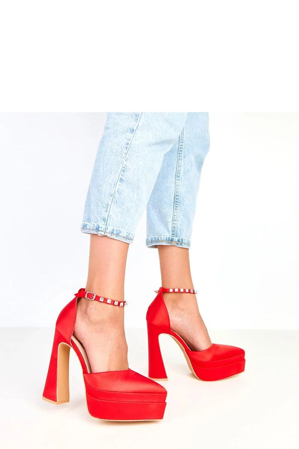 Red satin platform heels with studded ankle straps and chunky block heels.