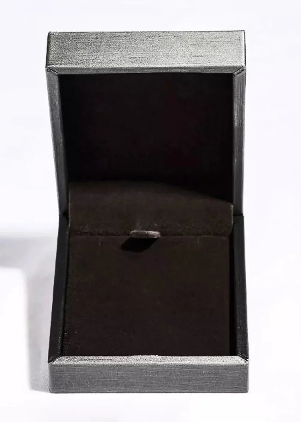 Close-up of an open silver jewelry box with a dark interior, showing texture.