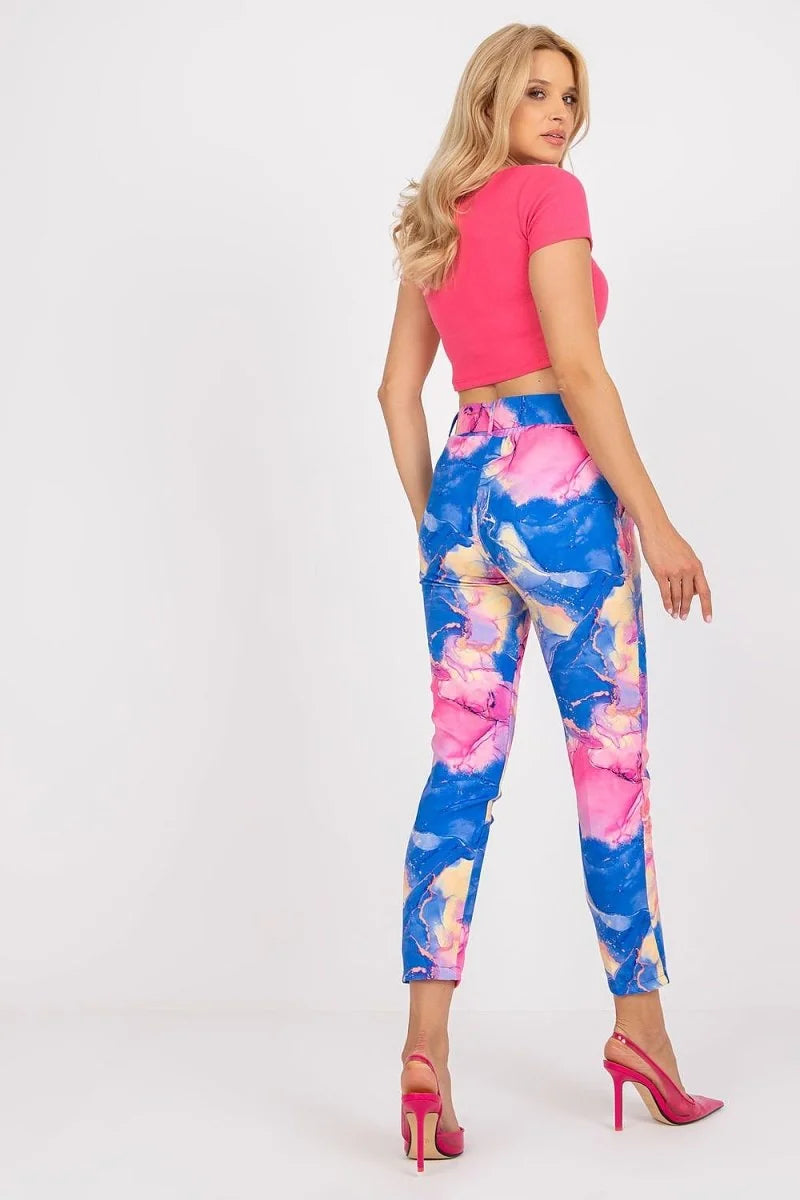 Women's high-waisted pants with a blue, pink, and yellow abstract marble print.