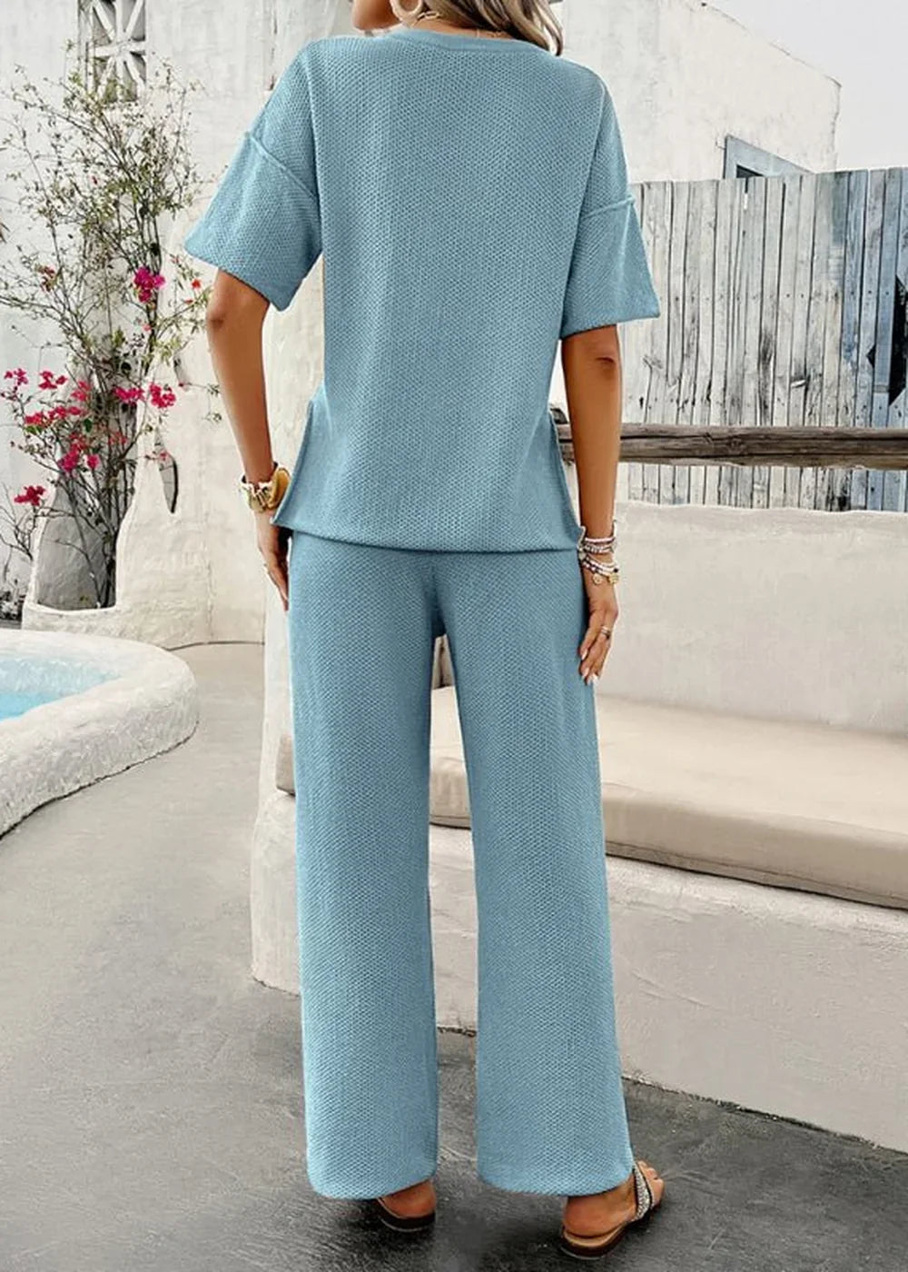 Light blue textured knit short-sleeve top and wide-leg pants set on a model.
