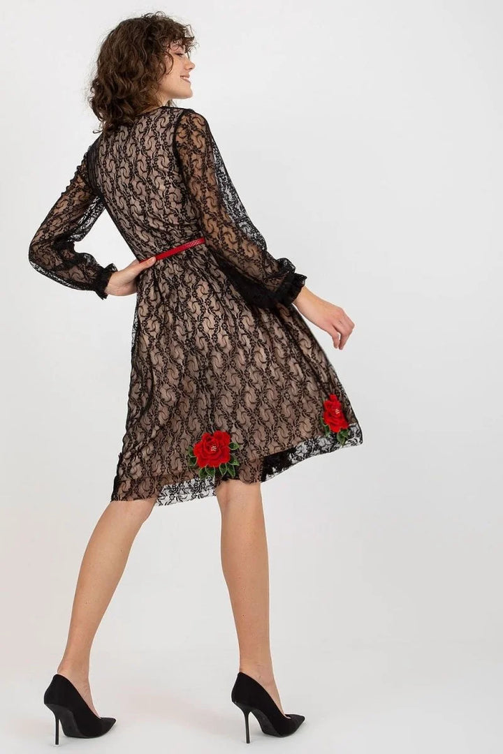 Black lace dress with red rose embroidery and a red belt, shown on a model.