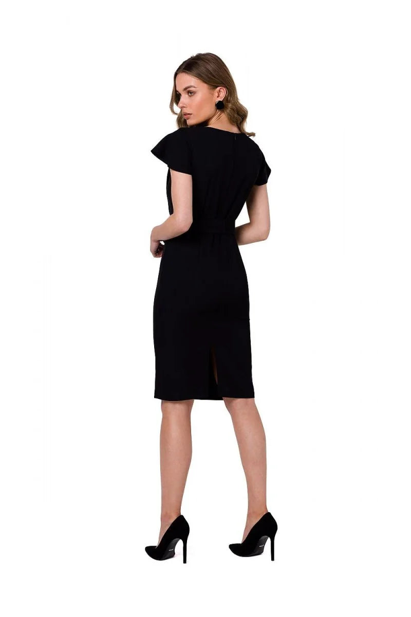 Back view of a black knee-length dress with a V-neck, short flutter sleeves, and a slit in the back.