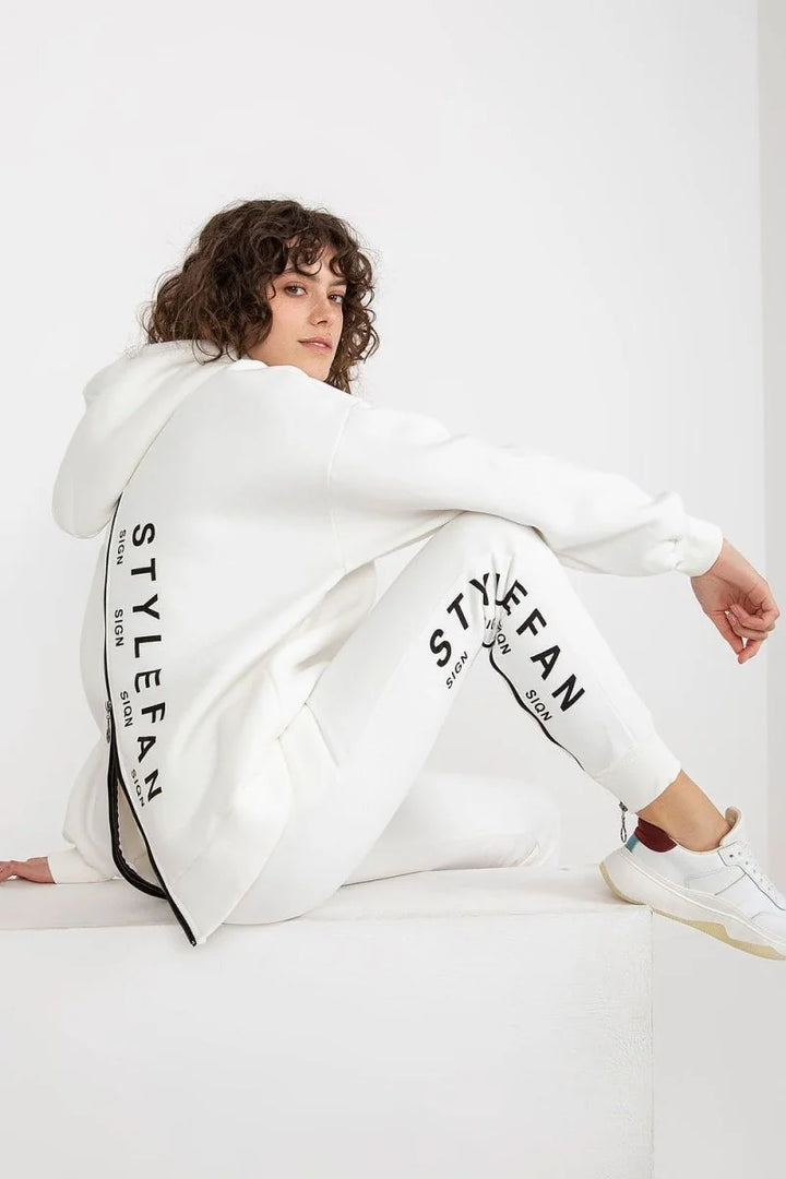 White relaxed fit sweatpants with black "STYLEFAN SIGN" lettering down the leg.