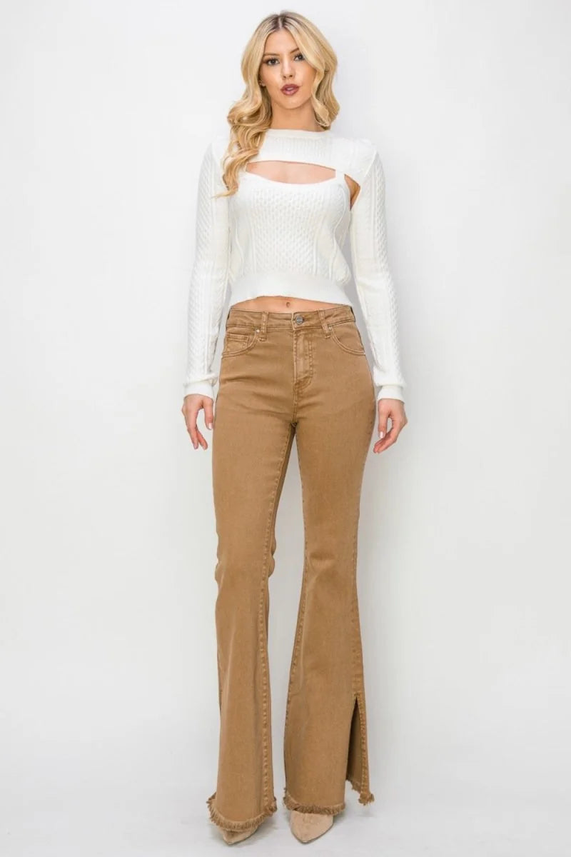 Tan high-waisted flared jeans with side slits and frayed hem on model.