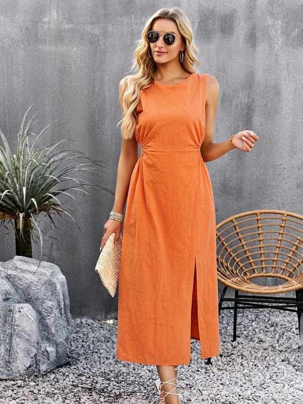 Orange sleeveless midi dress with a side slit and ruched detailing, worn by a woman with blonde hair and sunglasses.