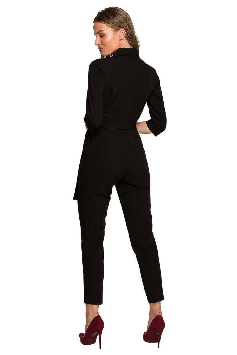 Black jumpsuit with belt and three-quarter sleeves on a model.