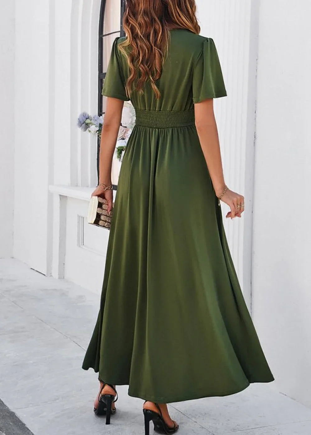 Olive green maxi dress with smocked waist and flutter sleeves, shown from the back.