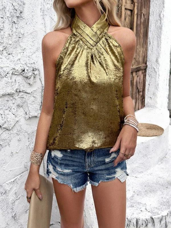 Gold metallic halter top with ruched neckline and distressed denim shorts.