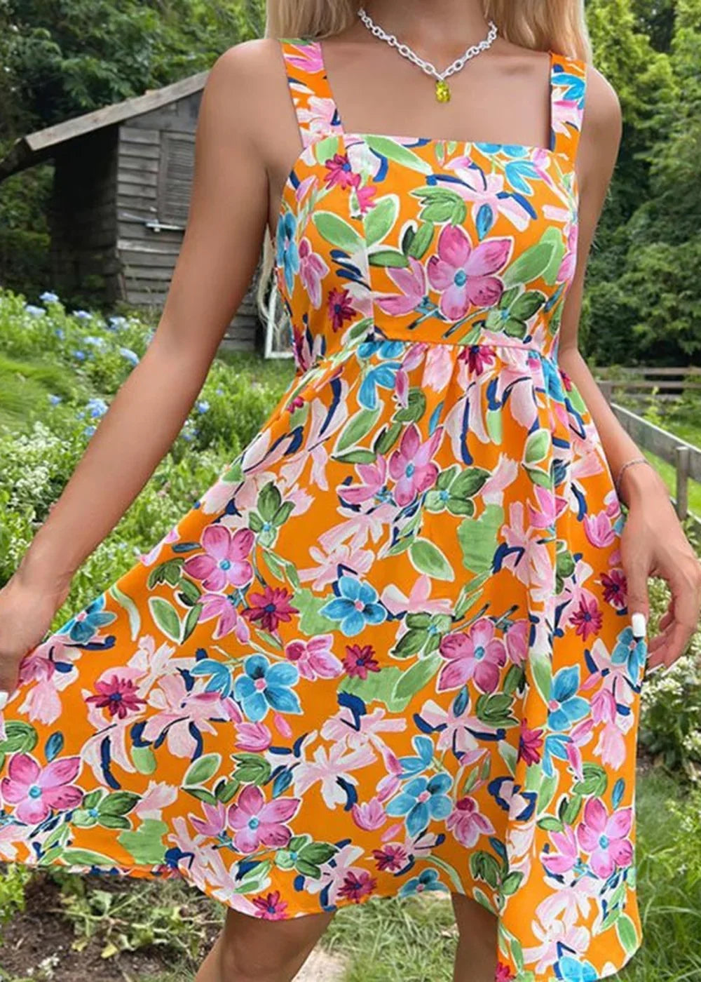 Orange floral print mini dress with a square neckline and adjustable straps.