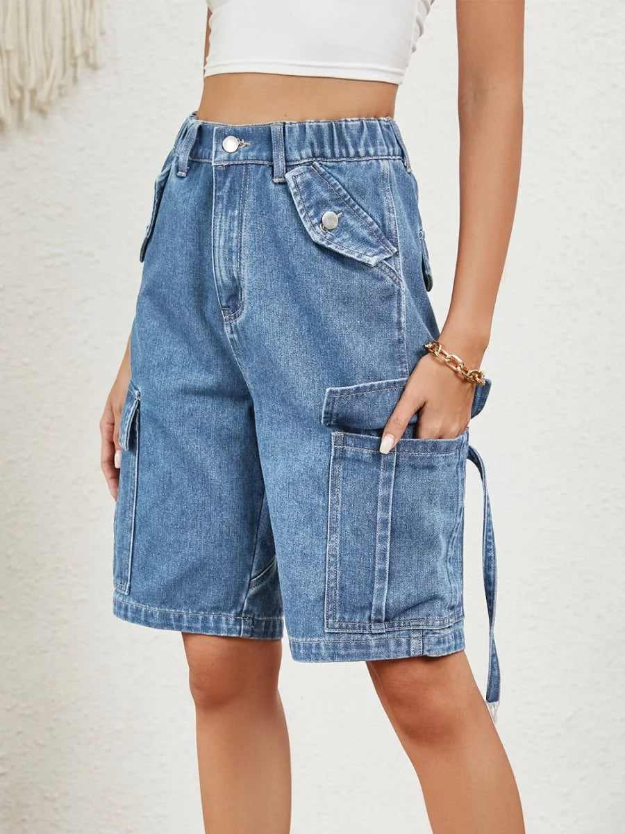 Light wash denim cargo shorts with elastic waistband and utility pockets.