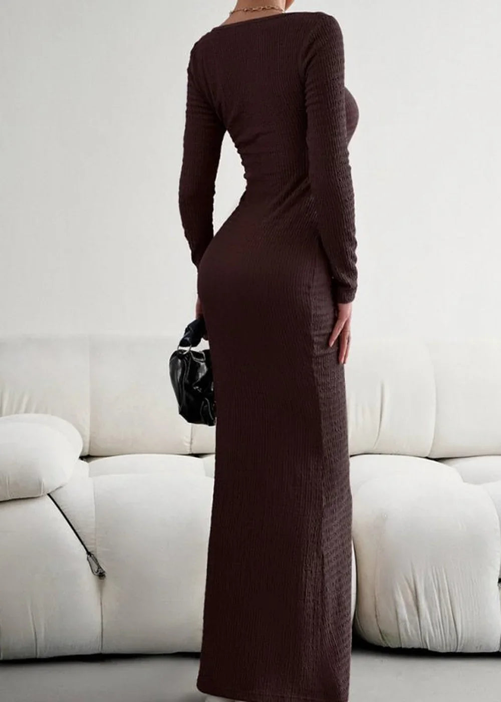 Long sleeve brown ribbed knit maxi dress with a fitted silhouette, shown from the back.