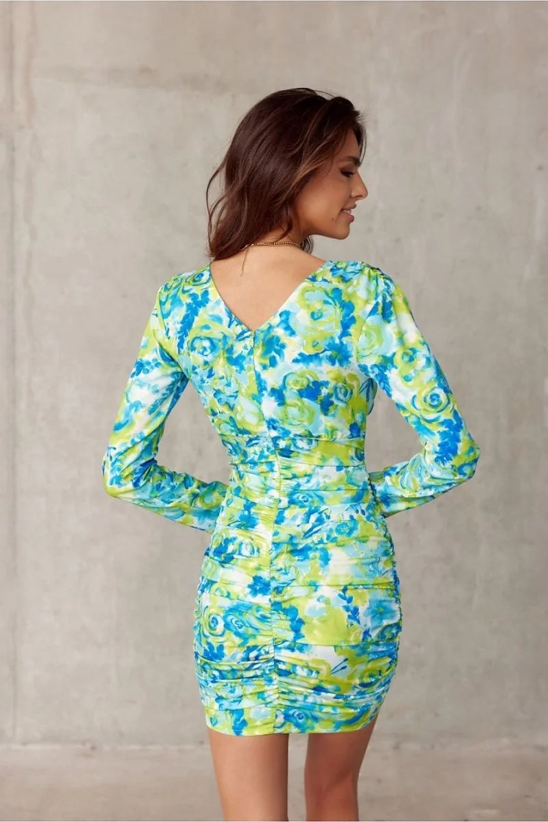 Fitted mini dress with a vibrant blue and green abstract floral print and ruched detailing.