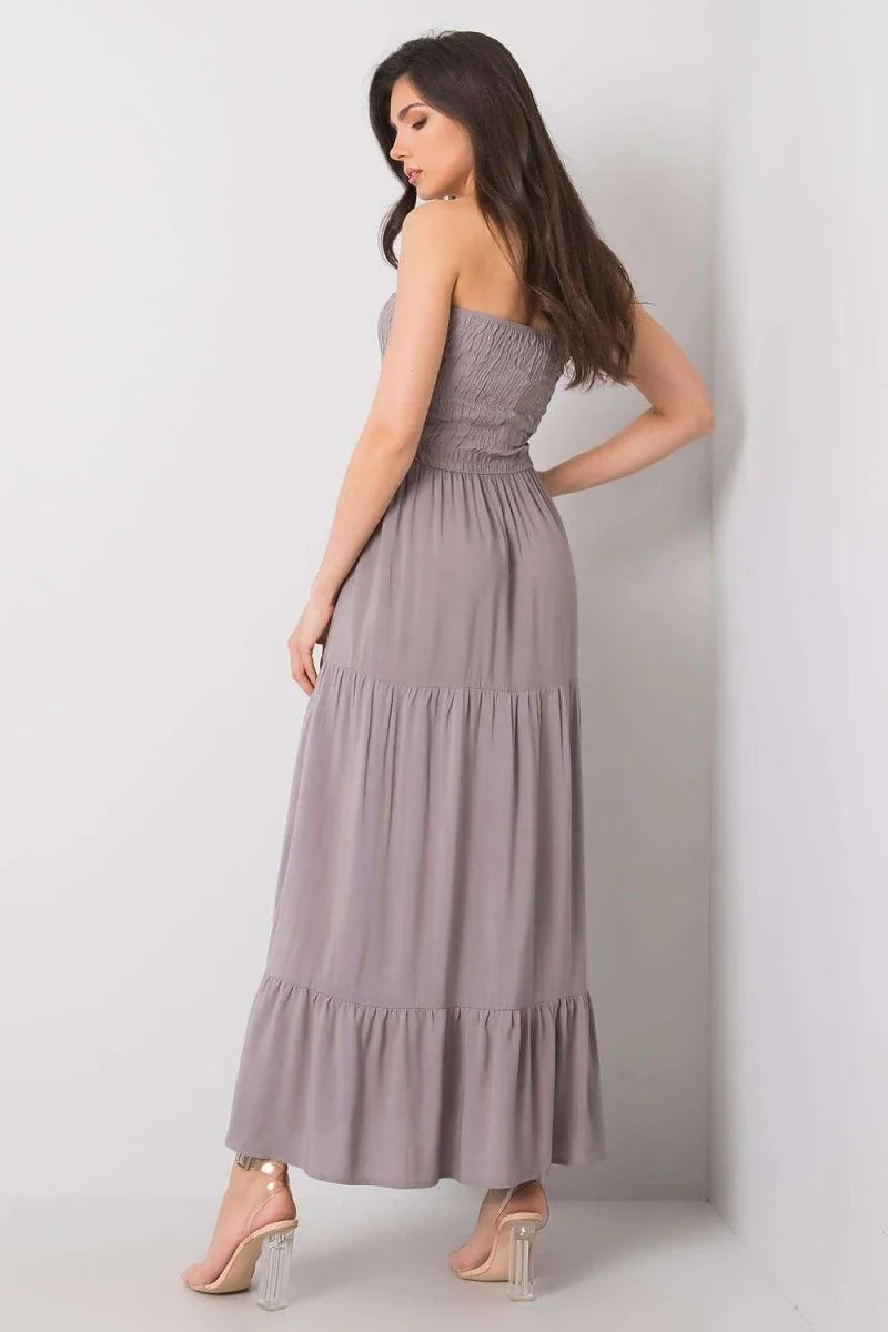 Taupe strapless tiered maxi dress with smocked bodice and clear block heels.